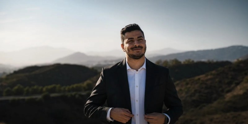 BC Game CEO Ali "Ako" Muhanned in a dark suit outdoors against hills